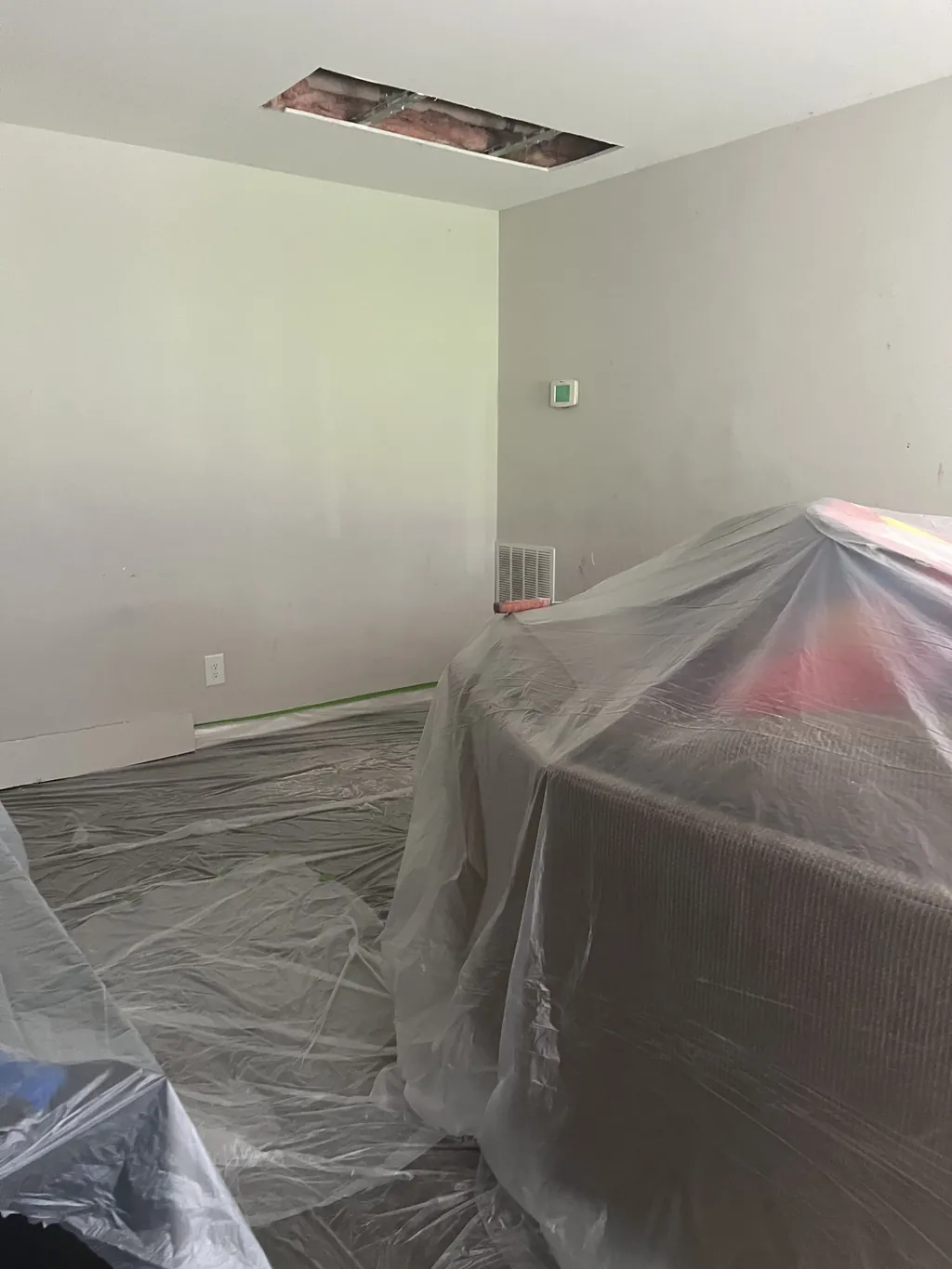 Room prepped and covered for a drywall ceiling repair